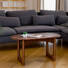 Living room with a dark gray sectional sofa and wooden coffee table.