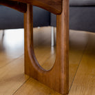 Wooden coffee table with a blurred sofa in the background